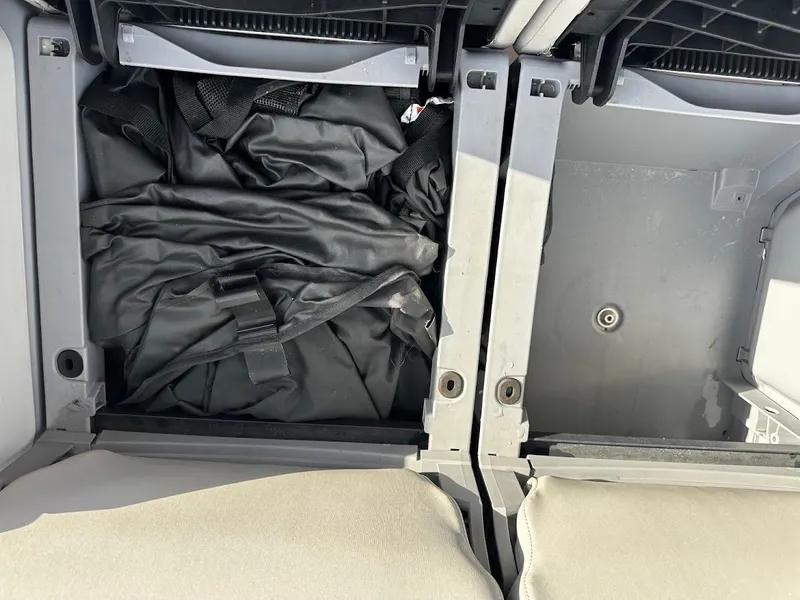 Slide: The Image of Storage compartment of 2023 Sea-Doo Switch Cruise 21 with black cover inside. - 24