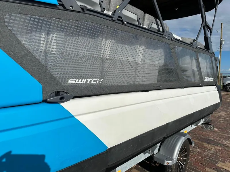 Slide: The Image of 2023 Sea-Doo Switch Cruise 21 boat, blue and white exterior, on a trailer. - 27