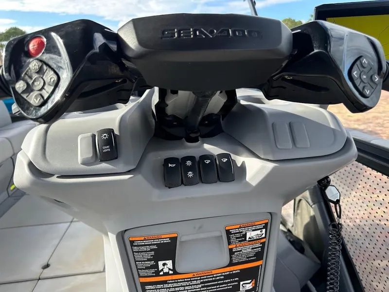 Slide: The Image of 2023 Sea-Doo Switch Cruise 21 dashboard with control buttons and steering wheel. - 9