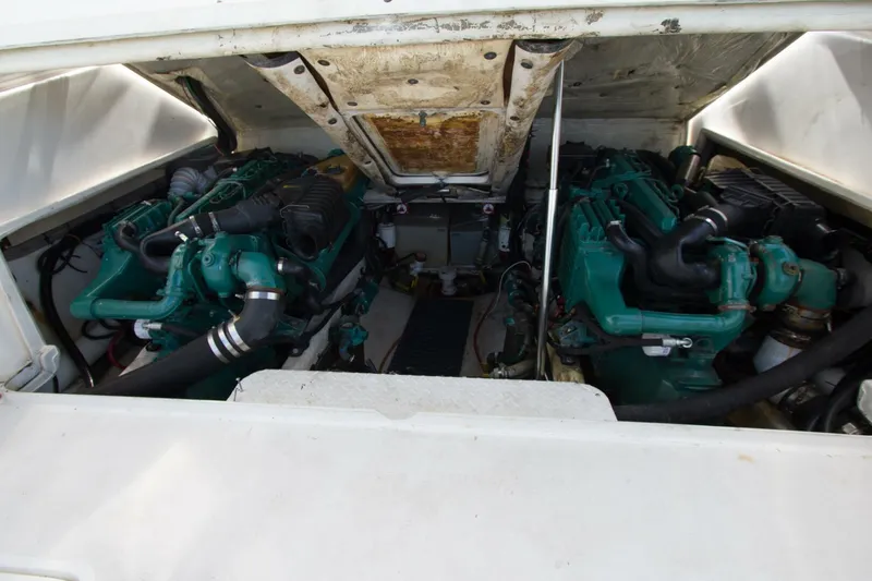 Slide: The Image of Engine compartment of 1997 Lazzara Aura Tournament boat, showcasing dual green engines. - 16