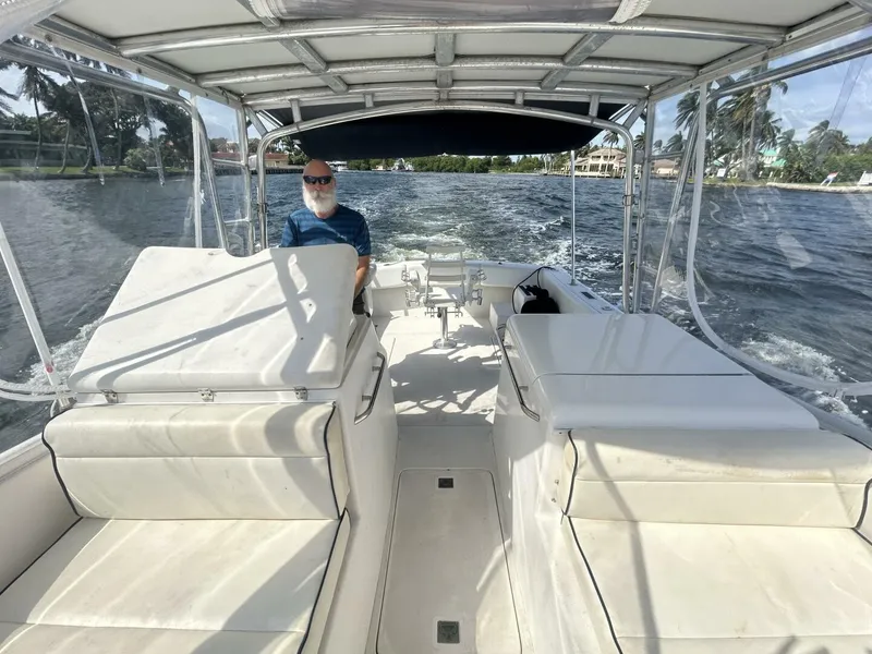 Slide: The Image of 1997 Lazzara Aura Tournament boat cruising on a sunny day with a person at the helm. - 4