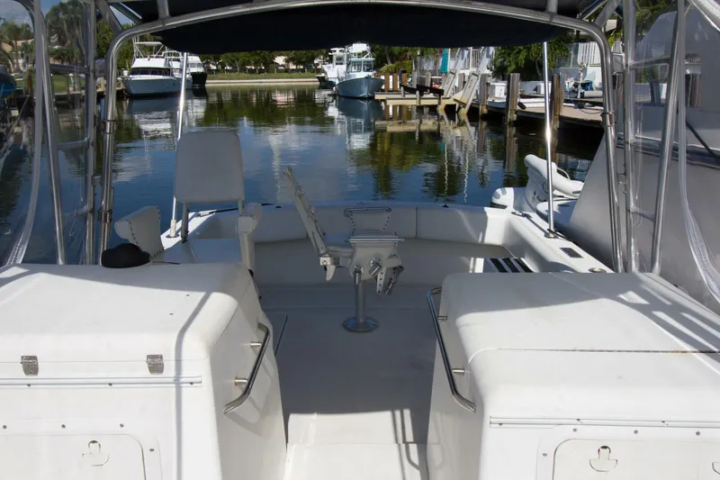 Slide: The Image of 1997 Lazzara Aura Tournament boat interior at a marina, featuring seating and fishing equipment. - 8
