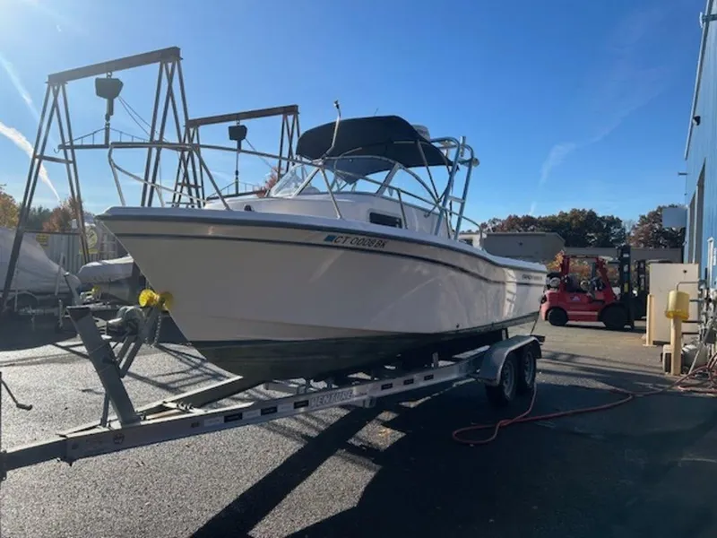 Slide: The Image of 2000 Grady-White 202 Adventure boat on trailer in sunny marina setting. - 10