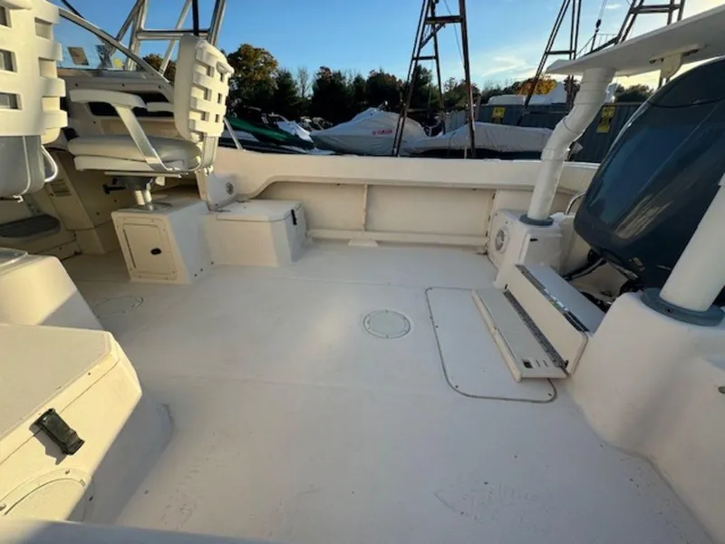 Slide: The Image of Spacious deck of 2000 Grady-White 202 Adventure boat, featuring seating and storage. - 8