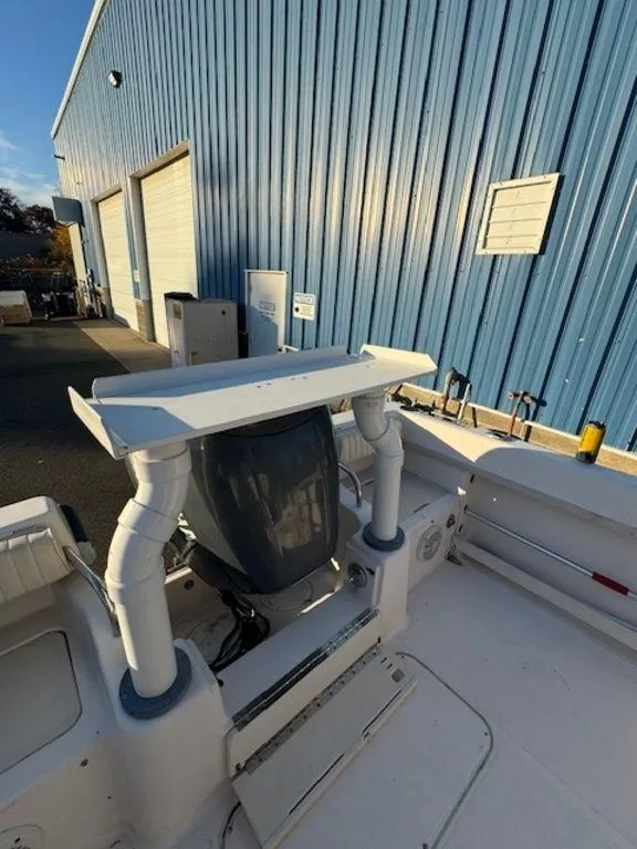 Slide: The Image of Grady-White 202 Adventure 2000 boat with outboard motor near blue warehouse. - 9