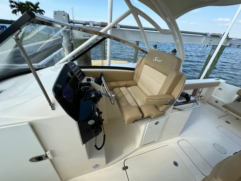 Slide: The Image of 2021 Scout 255 Dorado boat on calm water near luxury waterfront homes. - 10