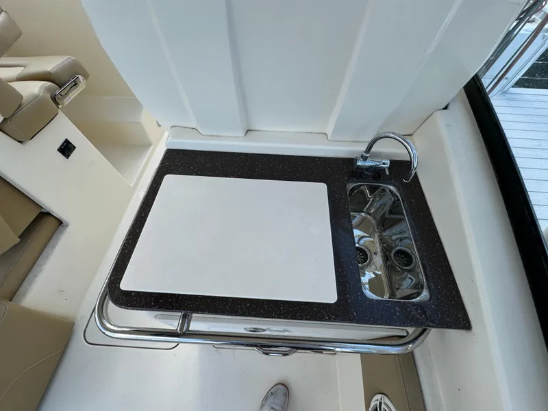 Slide: The Image of 2021 Scout 255 Dorado boat docked on lift by waterfront home. - 16