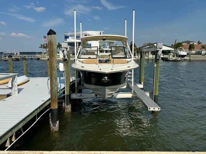 Slide: The Image of 2021 Scout 255 Dorado boat on calm water near waterfront homes. - 3