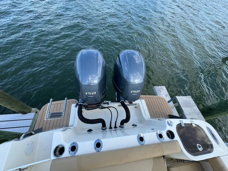 Slide: The Image of 2021 Scout 255 Dorado boat with twin 150 horsepower engines on water. - 30