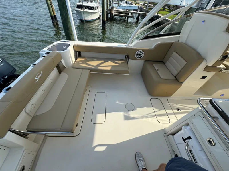 Slide: The Image of 2021 Scout 255 Dorado boat interior with beige seating and open deck. - 32