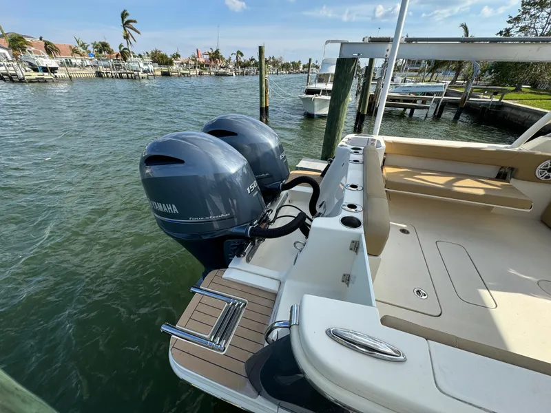 Slide: The Image of 2021 Scout 255 Dorado boat on calm blue water, featuring sleek design and spacious seating. - 5