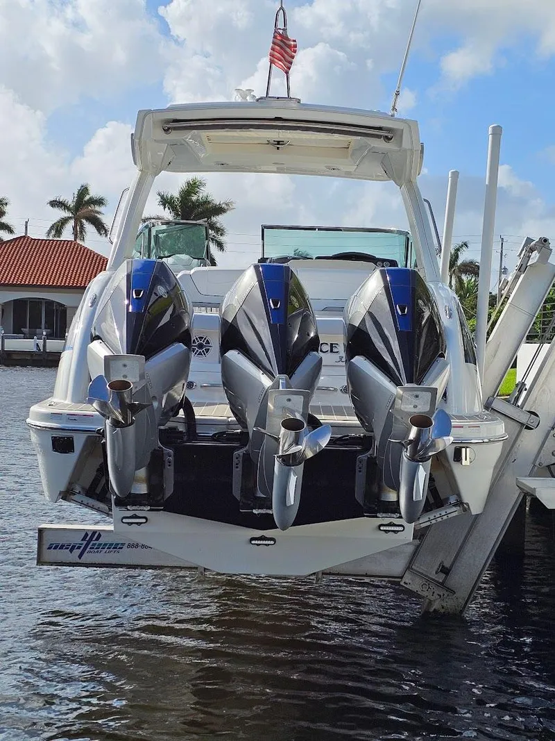 Slide: The Image of 2023 Formula 350 Crossover Bowrider with triple engines docked by waterfront. - 10