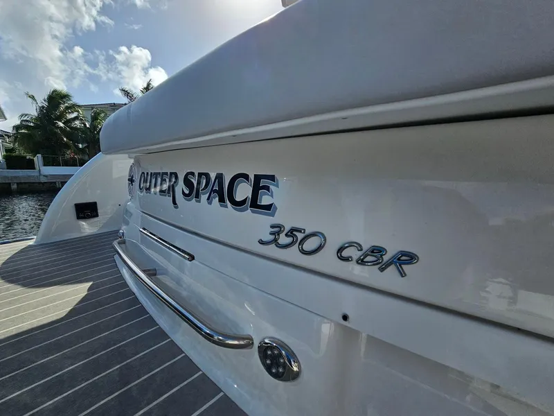 Slide: The Image of 2023 Formula 350 Crossover Bowrider, "Outer Space," docked under a sunny sky. - 14