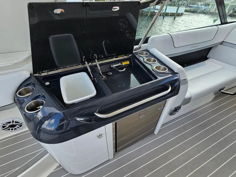 Slide: The Image of 2023 Formula 350 Crossover Bowrider interior with kitchenette and seating area. - 22
