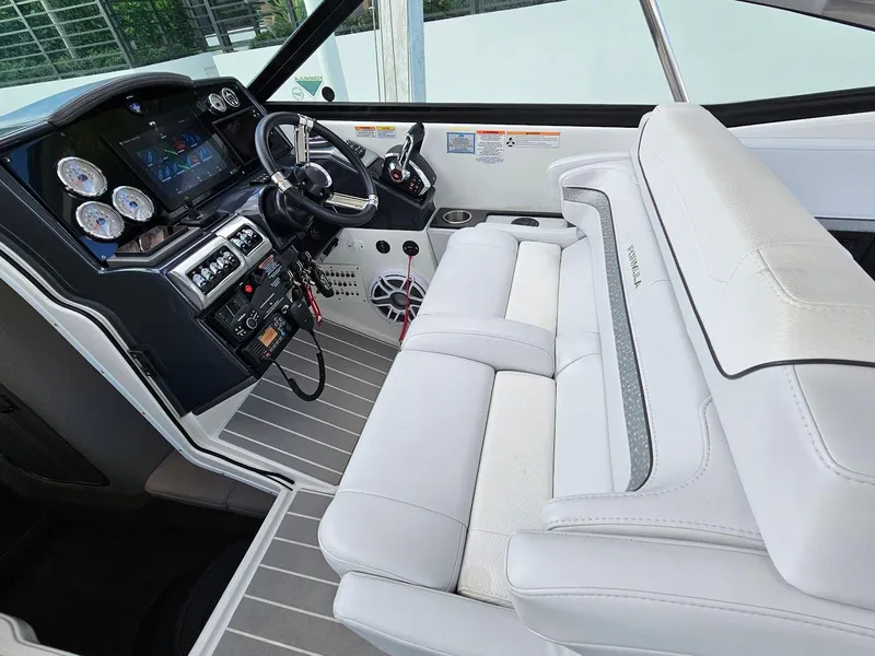 Slide: The Image of 2023 Formula 350 Crossover Bowrider interior with sleek dashboard and plush seating. - 23