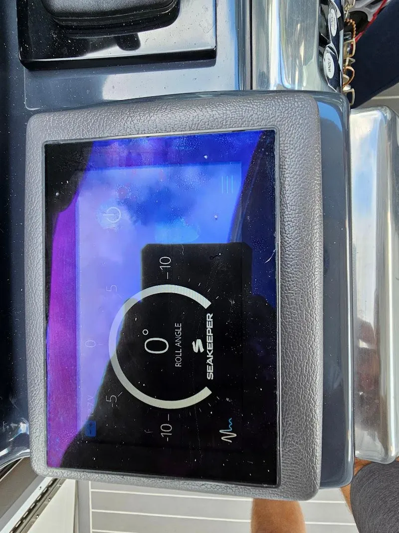 Slide: The Image of Seakeeper control panel on 2023 Formula 350 Crossover Bowrider boat dashboard. - 25