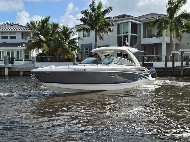 Slide: The Image of 2023 Formula 350 Crossover Bowrider cruising near waterfront homes and palm trees. - 3