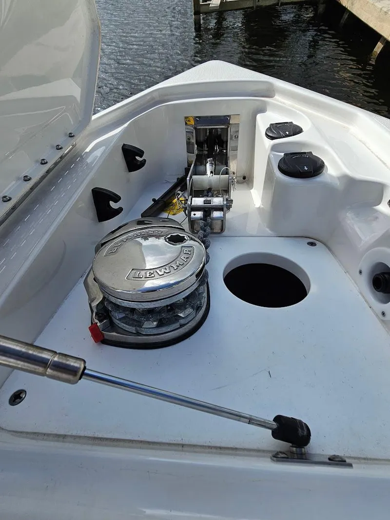 Slide: The Image of 2023 Formula 350 Crossover Bowrider anchor compartment with winch and storage. - 34