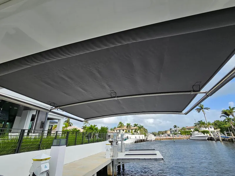 Slide: The Image of 2023 Formula 350 Crossover Bowrider with extended canopy at a marina. - 36