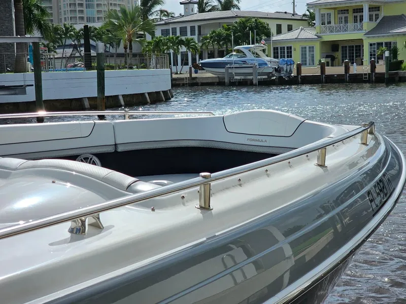 Slide: The Image of 2023 Formula 350 Crossover Bowrider docked near waterfront homes. - 39