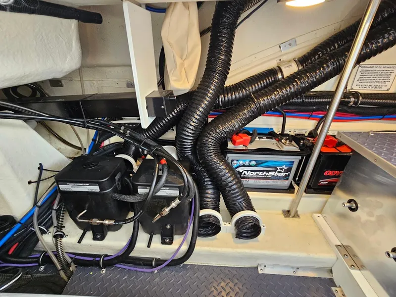 Slide: The Image of 2023 Formula 350 Crossover Bowrider engine compartment with batteries and wiring. - 42