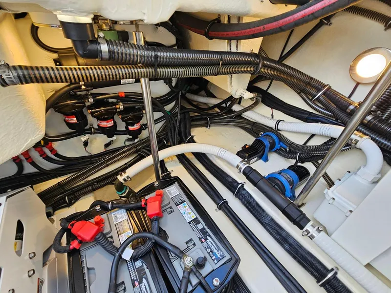 Slide: The Image of 2023 Formula 350 Crossover Bowrider engine compartment with wiring and battery setup. - 47