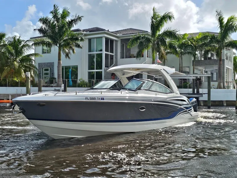 Slide: The Image of 2023 Formula 350 Crossover Bowrider in front of a modern waterfront home. - 6