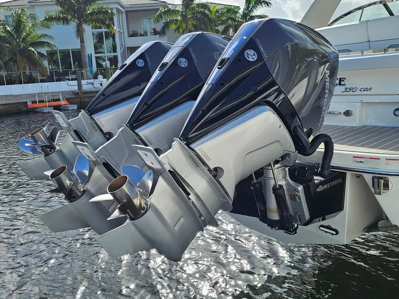 Slide: The Image of Triple outboard engines on a 2023 Formula 350 Crossover Bowrider in a marina setting. - 9