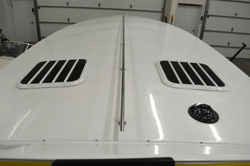 Slide: The Image of 1980 Sutphen 30 Oceanpacer boat deck with vents in a garage setting. - 10