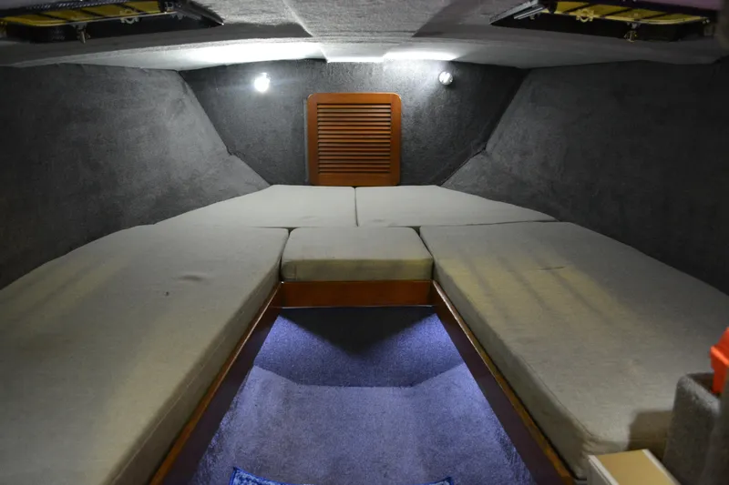 Slide: The Image of Interior cabin of 1980 Sutphen 30 Oceanpacer boat with cushioned seating and ambient lighting. - 11