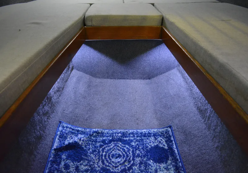 Slide: The Image of Interior of 1980 Sutphen 30 Oceanpacer with blue carpet and seating. - 12