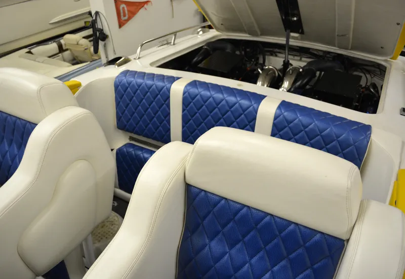 Slide: The Image of 1980 Sutphen 30 Oceanpacer interior with blue and white quilted seats, open engine compartment. - 15