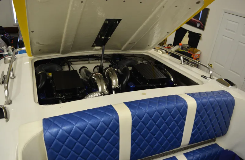 Slide: The Image of 1980 Sutphen 30 Oceanpacer boat engine with blue quilted seats in a garage. - 17