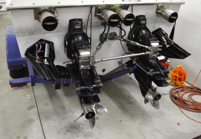 Slide: The Image of 1980 Sutphen 30 Oceanpacer boat with dual outboard motors in a garage setting. - 24