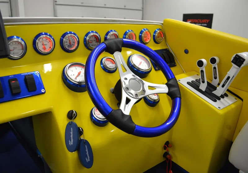 Slide: The Image of 1980 Sutphen 30 Oceanpacer dashboard with vibrant yellow and blue accents, gauges, and controls. - 5