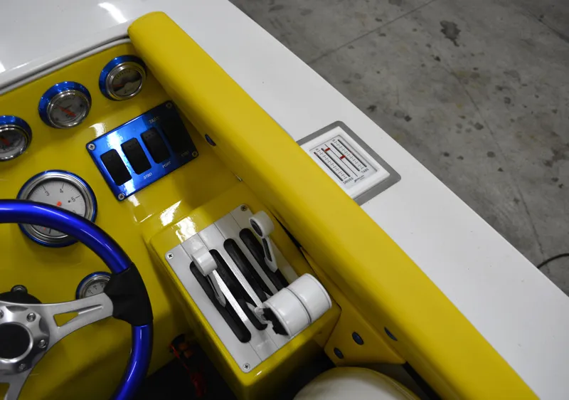 Slide: The Image of 1980 Sutphen 30 Oceanpacer dashboard with yellow accents and steering wheel. - 7