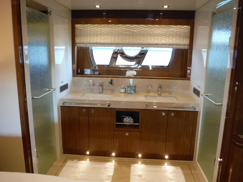 Slide: The Image of Luxurious bathroom in 2015 Horizon E88 yacht with dual sinks and elegant wood cabinetry. - 40