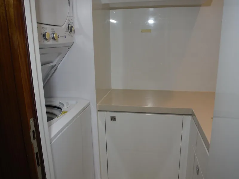 Slide: The Image of Compact laundry area with stacked washer and dryer on Horizon E88 yacht, 2015 model. - 45