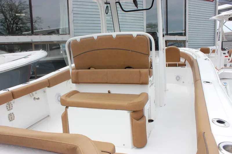 Slide: The Image of 2021 Sea Hunt Ultra 265 SE boat interior with tan seating and white deck. - 10