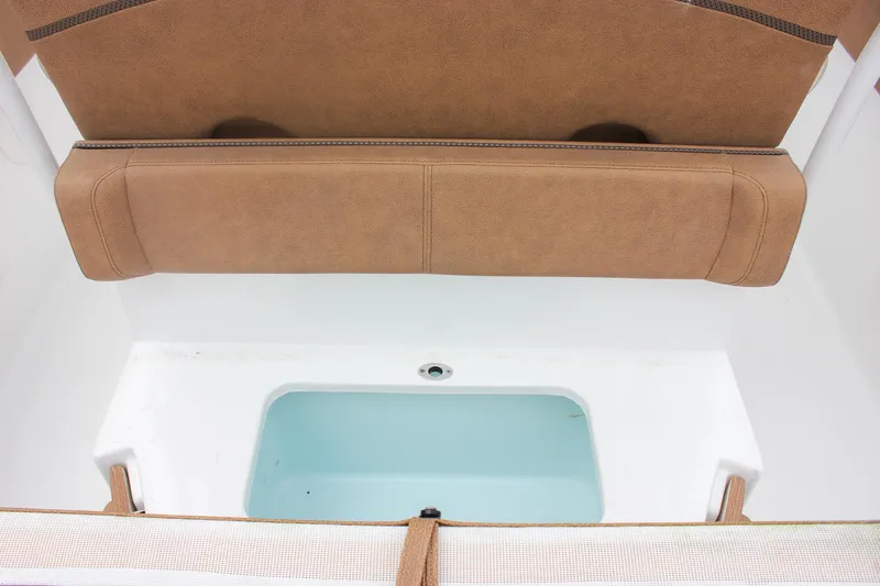 Slide: The Image of 2021 Sea Hunt Ultra 265 SE boat interior with cushioned seating and storage compartment. - 12