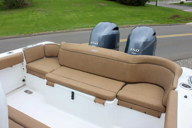 Slide: The Image of 2021 Sea Hunt Ultra 265 SE boat with tan seating and dual 150 engines. - 13