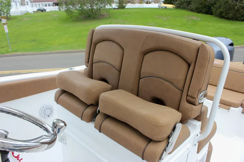 Slide: The Image of 2021 Sea Hunt Ultra 265 SE boat with comfortable brown seating and steering wheel. - 14