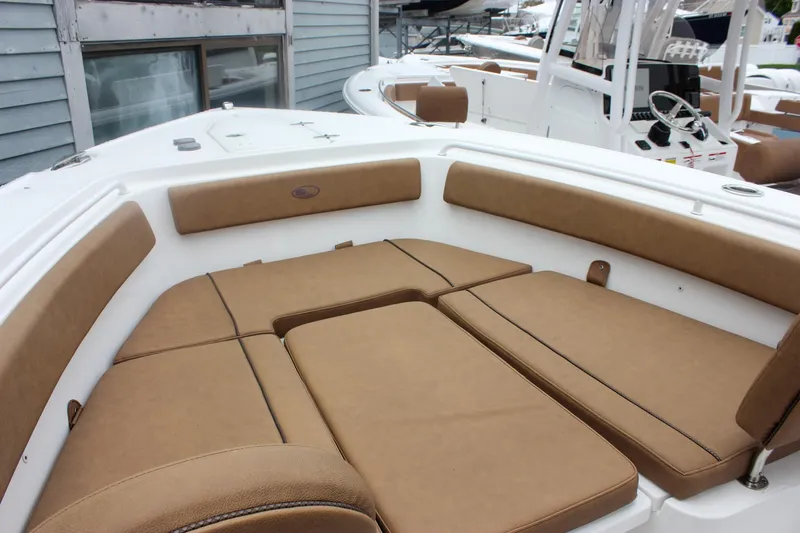 Slide: The Image of 2021 Sea Hunt Ultra 265 SE boat with tan cushioned seating in the bow area. - 17