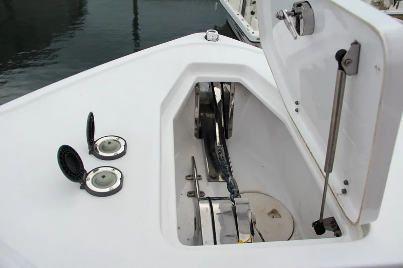 Slide: The Image of Anchor compartment of 2021 Sea Hunt Ultra 265 SE boat. - 23
