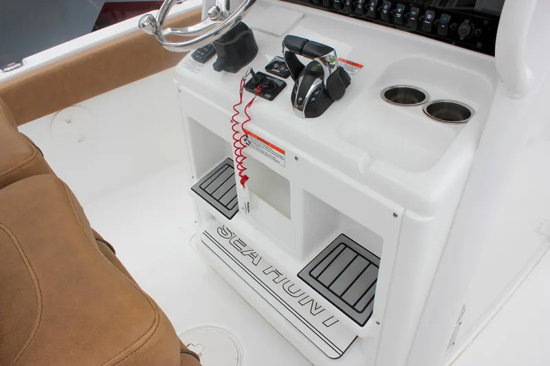 Slide: The Image of 2021 Sea Hunt Ultra 265 SE boat console with controls and cup holders. - 25