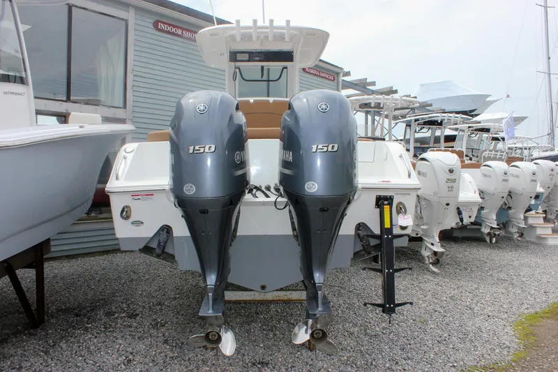 Slide: The Image of 2021 Sea Hunt Ultra 265 SE boat with dual Yamaha 150 engines, displayed outdoors. - 27