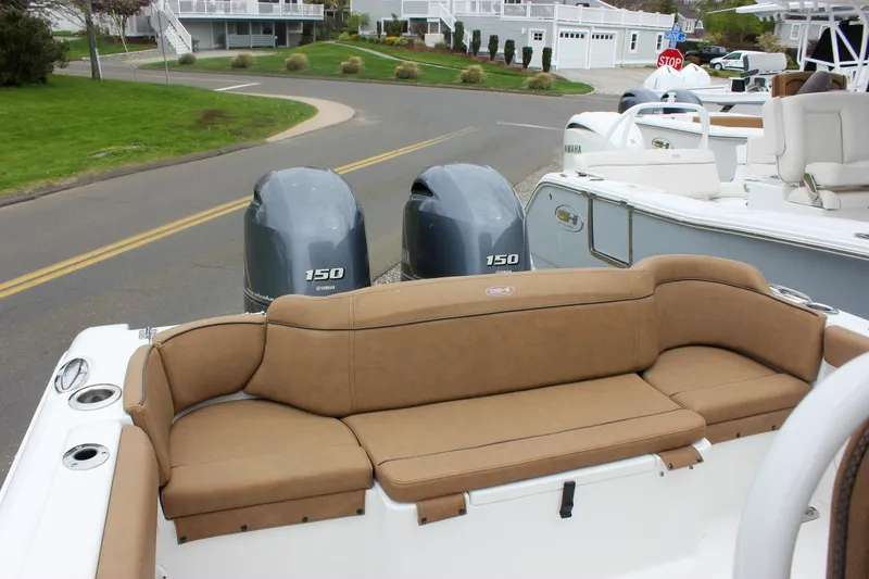 Slide: The Image of 2021 Sea Hunt Ultra 265 SE boat with twin 150 engines and tan seating. - 28