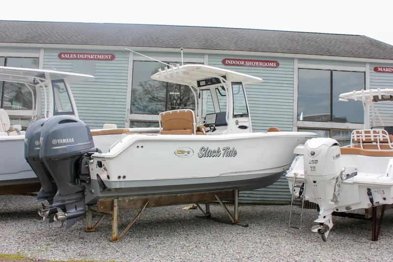 Slide: The Image of 2021 Sea Hunt Ultra 265 SE boat with Yamaha engines, displayed outside a showroom. - 29