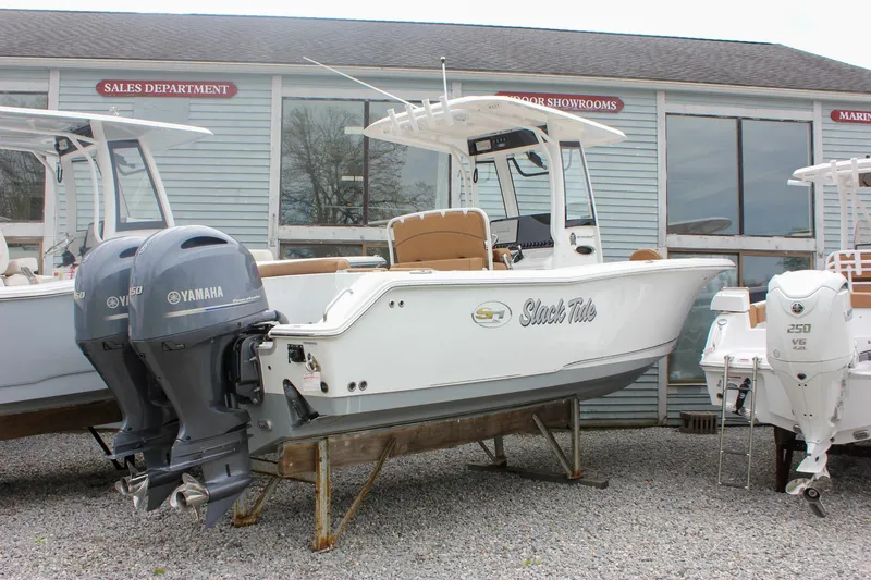 Slide: The Image of 2021 Sea Hunt Ultra 265 SE boat with dual Yamaha engines displayed outdoors. - 30