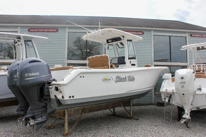 Slide: The Image of 2021 Sea Hunt Ultra 265 SE boat with Yamaha engine displayed at a marina showroom. - 32